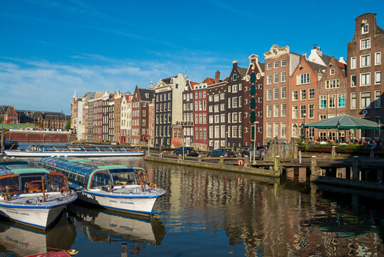 The Netherlands, North Holland Province, Amsterdam, Damrak, Tourboats and port buildings