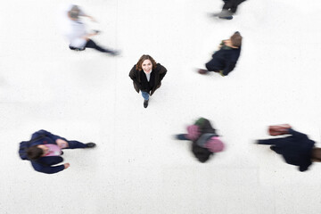 Portrait of woman amidst moving people