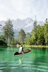 Fototapeta na wymiar Canoeist on Lake Eibsee, Bavaria, Germany