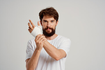 sick man bandaged hand injury to fingers hospitalization isolated background © SHOTPRIME STUDIO