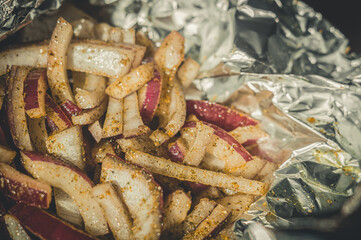 Pickled red onion. Cutting red onions in foil for baking in the oven. Cooking. Selective focus