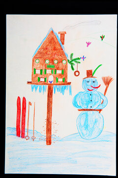 Children's drawing of snowman, skis and birdhouse