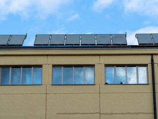 Fototapeta premium Solar panels on the building roof during sunny day view