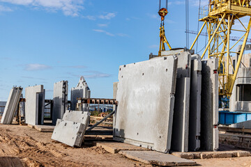 Many precast concrete wall panels are stocking in the storage area waiting for installation at...