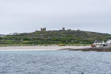 Fototapeta premium view over Aran Islands with atlantic ocean and old castle on the hill