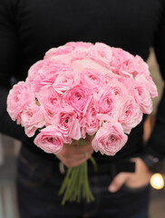 Flowers bouquet of pink ranunculus. Holiday celebration concept. Bouquet of beautiful flowers in hands. Pink fresh flowers.