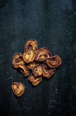 Obraz premium Dried apricots on rustic dark background