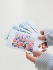 Postcard with flower in woman's hands.