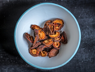 Dried apricots on rustic dark background