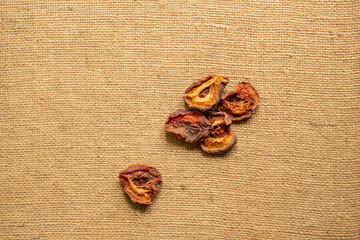 Single dried apricot currant on rustic brown canvas