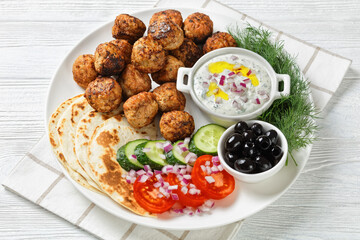 Keftedakia, fried greek meatballs on white platter