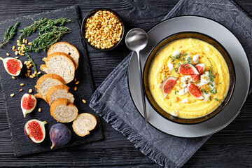 Pumpkin cream soup with thyme with feta and figs
