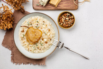 Homemade risotto with gorgonzola cheese, pear and walnuts. Top view. Copy space. - obrazy, fototapety, plakaty
