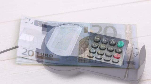Animation of euro banknotes falling over payment terminal