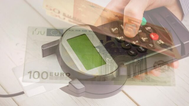 Animation of euro banknotes falling over hand of caucasian man holding payment terminal