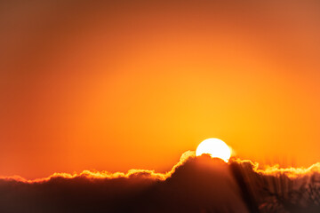 sun setting behind the clouds