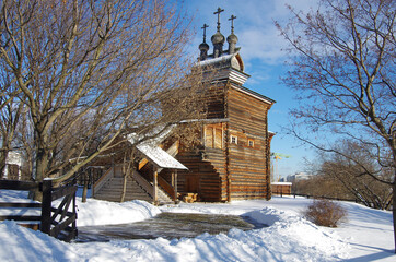 MOSCOW, RUSSIA - February, 2021: Winter day in the Kolomenskoye estate. Church Of St. George The Great Martyr. Three chapters with crosses, wooden architecture of the XVII century