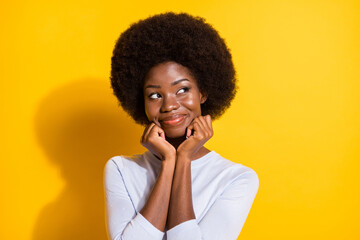 Fototapeta na wymiar Portrait of pretty positive dark skin person hands on cheeks look empty space isolated on yellow color background