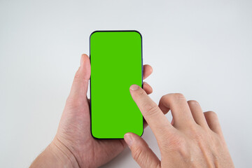 hand holds smartphone on chroma key