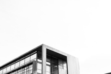 Black and White building architecture detail with sky on background. Futuristic Architecture background with copyspace  and dramatic sky and realistic building