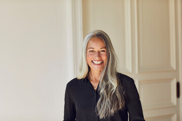 Cheerful woman standing at home