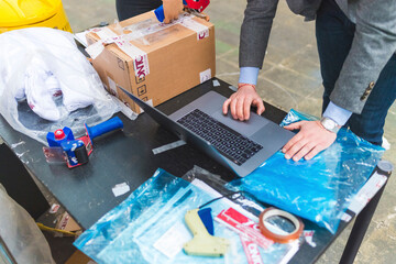 Businessman using laptop on table in a warehouse