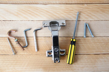 Set of tools and accessories for assembling furniture on the wooden background