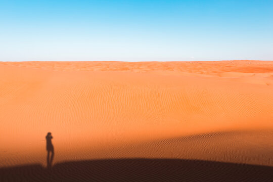 Shadow of a man, standing in the desert, Wahiba Sands, Oman