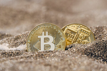 Bitcoin digital currency coins on the beach