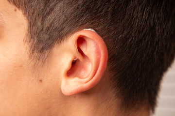People with wireless hearing aids in the ear