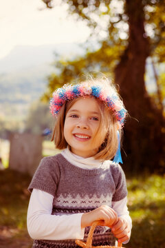Portrait of a smiling young girl with hair wreath outdoors