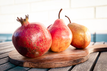 Seasonal fruit: pomegranates, apples and pears. Ripe fruit photography