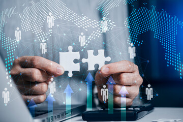 Businesswoman holding a connecting jigsaw puzzle and global network connection, Business success and strategy concept.