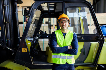 Portrait of confident worker at forklift in factory