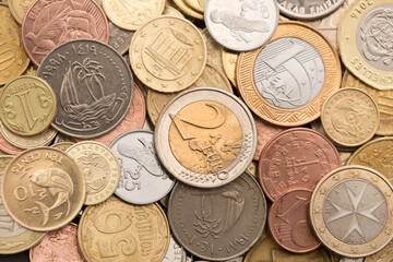 Different money coins. US dollars money and euro as a background on a flat lay. Savings and economy. Coins of different denominations from different countries. Inflation and exchange rates.