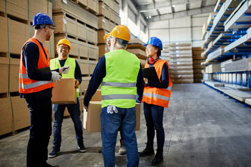 Workers talking in factory warehouse