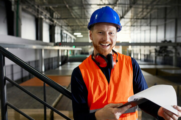Portrait of happy worker in factory warehouse