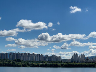 Fototapeta premium city skyline with beautiful white clouds in the blue sky 