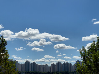 city skyline with beautiful white clouds in the blue sky