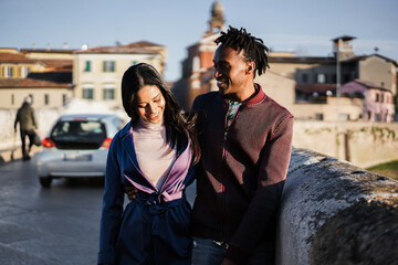 Fototapeta premium Young african couple having fun walking around the city - Travel concept - Focus on girl face