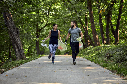 Couple plogging on forest path