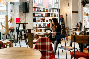Woman reading a book in coffee shop