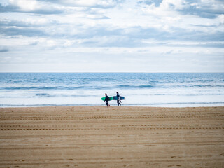 Surfers walking