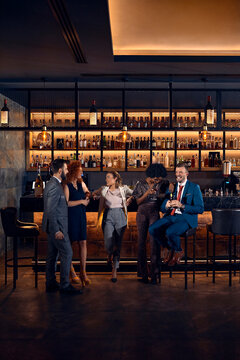 Friends socializing at the counter in a bar