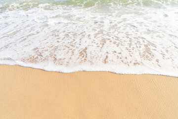 Fototapeta na wymiar Clean sand texture with sea wave.Sea tropical sandy beach for Summer background banner