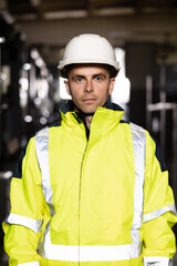 Portrait of caucasian heavy industry engineer worker posing confident to camera wearing hardhat and uniform. Business people in hard hat or safety wear. Electrician, electric worker