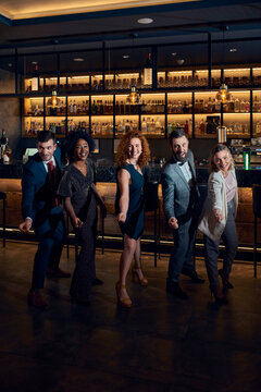 Portrait of cheerful friends having a party in a bar