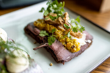 Smorrebrod sandwich in  Smorgasbord buffet, scandinavian typical open sandwich with hering and beef...