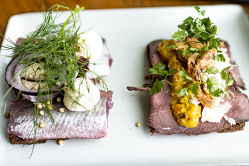 Smorrebrod sandwich in  Smorgasbord buffet, scandinavian typical open sandwich with hering and beef...