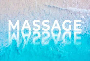 The word MASSAGE written by the ocean with a wave on the beach. Background for advertising